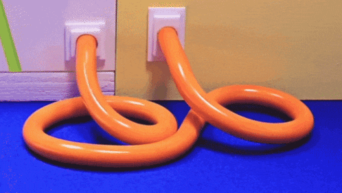 a pair of orange tubes are connected to a wall socket