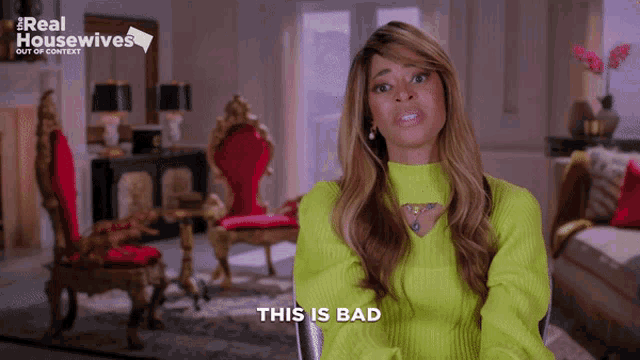 a woman in a green sweater says " this is bad " in a living room