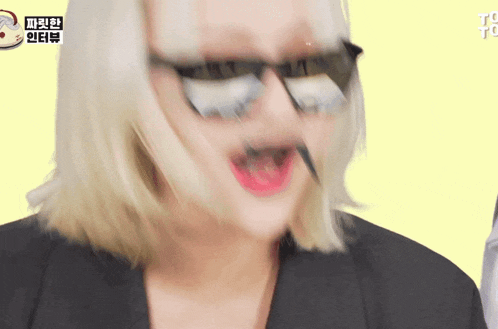 a close up of a woman wearing sunglasses and a black jacket