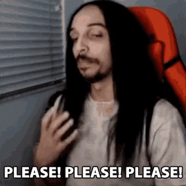 a man with long hair and a beard is sitting in an orange chair and says please ! please ! please !