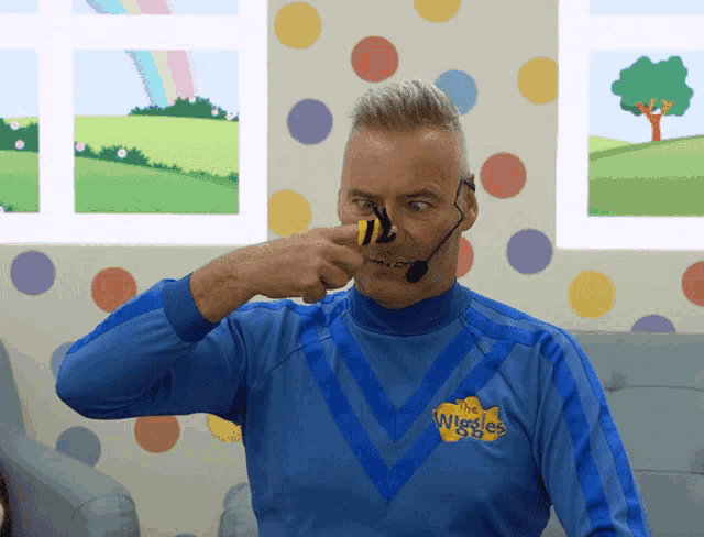 a man wearing a blue shirt with the wiggles on it