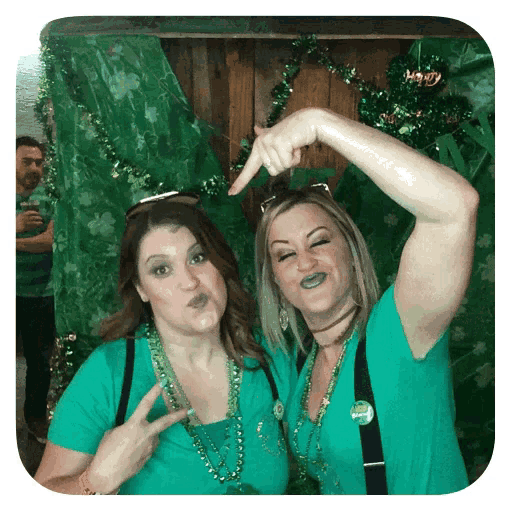 two women are posing for a picture and one has a badge that says happy