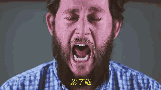 a man with a beard and a plaid shirt is yawning
