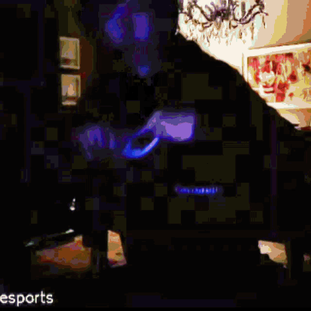 a man wearing headphones and sunglasses is dancing in a dark room