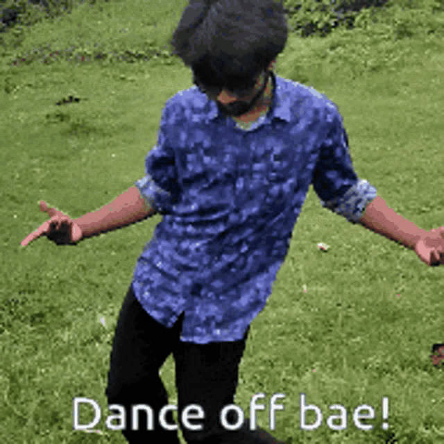 a man in a blue shirt is dancing in the grass with the words dance off bae written below him