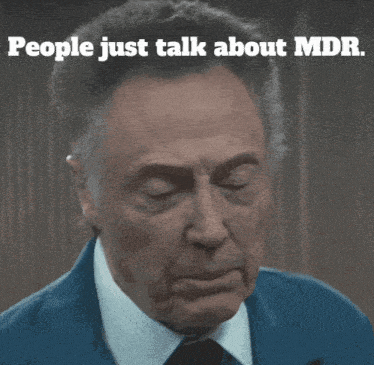 a man in a suit and tie with the words people just talk about mdb above him