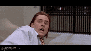 a man in a white shirt and tie is making a surprised face