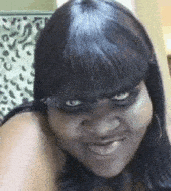 a close up of a woman making a funny face with her mouth open .