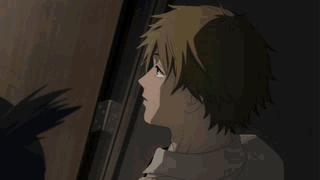 a man looking out a door with a shadow on the wall
