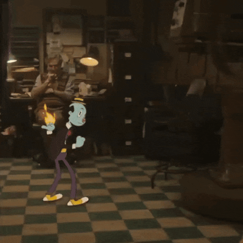 a man sits in a chair in a room with a cartoon character in front of him