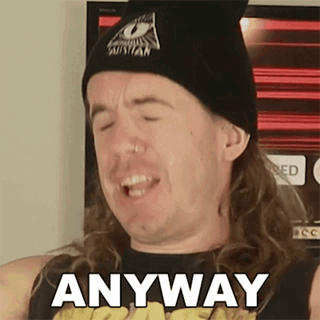 a man with long hair and a beanie is making a funny face and saying anyway .