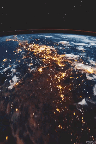 an aerial view of the earth at night with lights visible