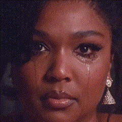 a close up of a woman 's face with a tear running down her face .