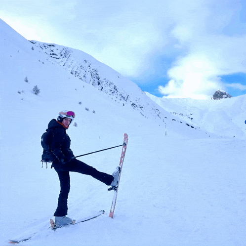 a person is skiing down a snow covered slope