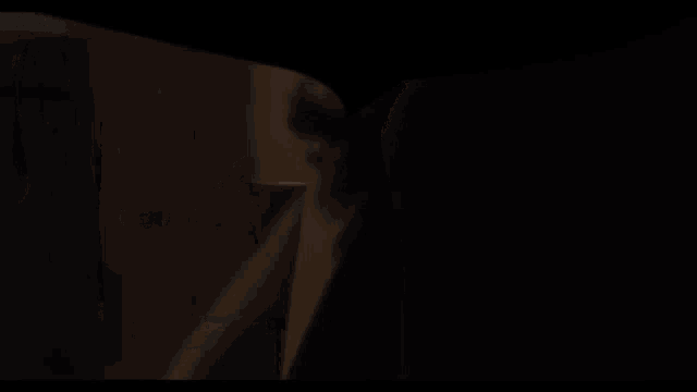 a close up of a person 's shoulder in the dark