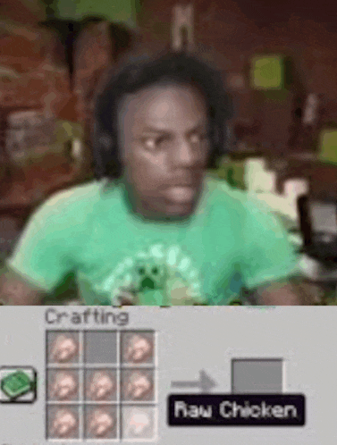a man in a green shirt is sitting at a table in front of a crafting table .
