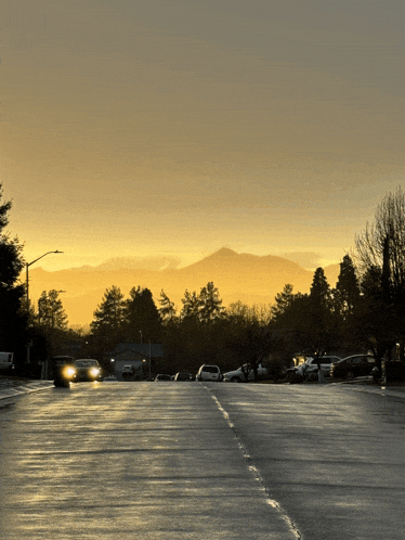 a car is driving down a street at sunset