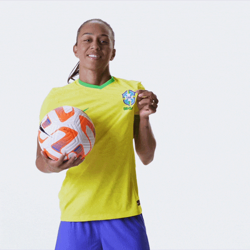a woman wearing a yellow shirt that says brasil on it
