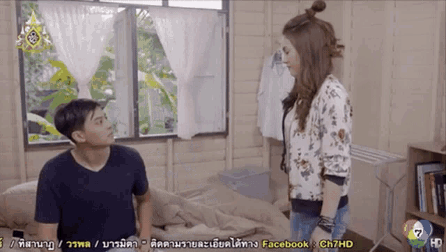 a man and a woman are standing in front of a window with facebook ch7hd written on the bottom