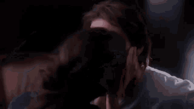 a man and a woman are hugging each other in a room .