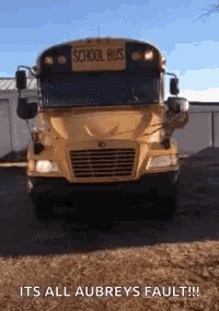 a yellow school bus is parked in front of a building with the caption " its all aubrey 's fault "