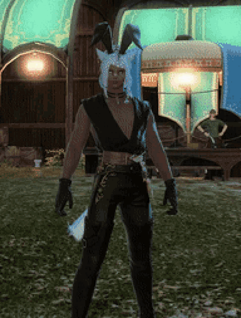 a man in a bunny costume is standing in a grassy area