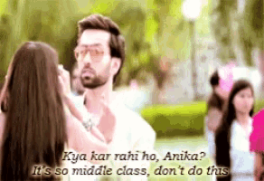 a man and a woman are standing next to each other and the woman is asking the man if he is in middle class .