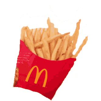 a red mcdonald 's box filled with french fries on a white background
