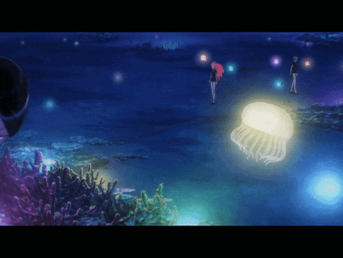 a jellyfish is glowing in the water with two people standing in the background