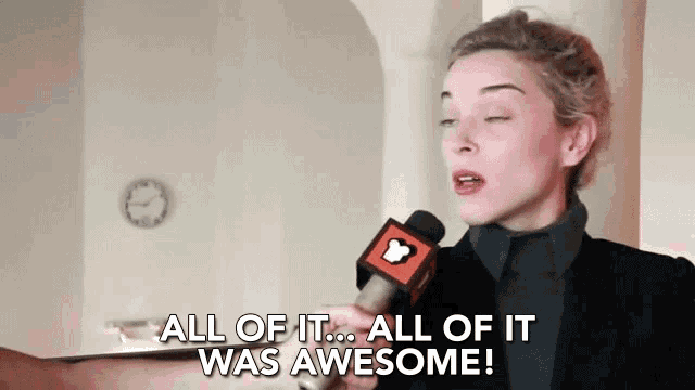 a woman is talking into a microphone and says all of it was awesome