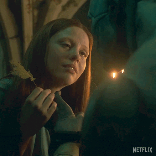 a netflix ad shows a woman holding a leaf and a candle
