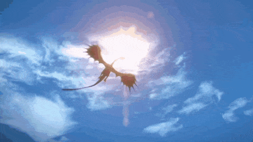 a dragon flies through a blue sky with the sun shining through the clouds