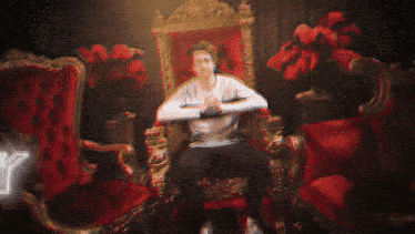 a man is sitting on a throne with the word ick in the background