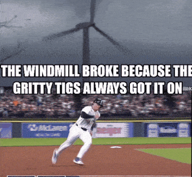 a baseball player on a field with a windmill in the background