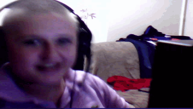 a person wearing headphones looks at the camera