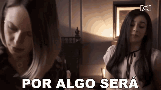 two women are standing next to each other and the words por algo sera are on the bottom