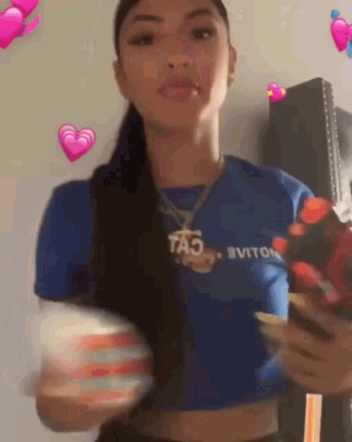 a woman wearing a blue crop top and a necklace with the word tao on it .