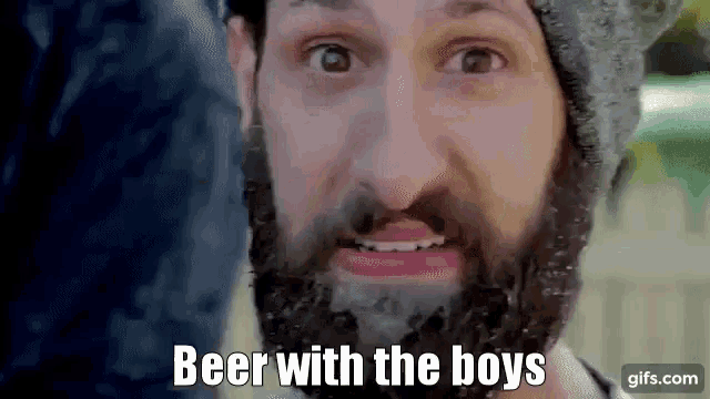a man with a beard and a hat is talking about beer with the boys .