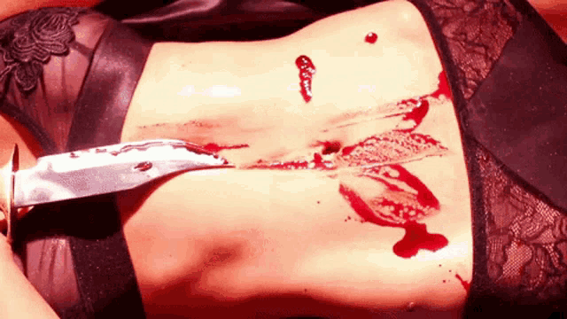 a woman with a knife stuck in her stomach