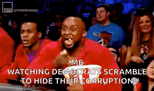 a man is eating popcorn in a crowd while watching democrats scramble to hide their corruption .
