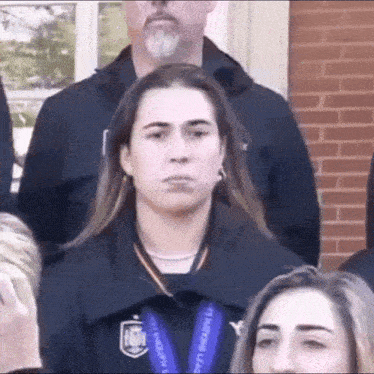 a woman wearing a medal around her neck that says ' u.s. soccer league ' on it