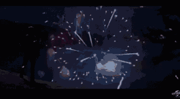 a man is standing in front of a fireworks display in the dark .