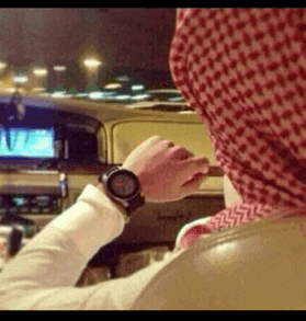 a man wearing a scarf and a watch is looking at his watch