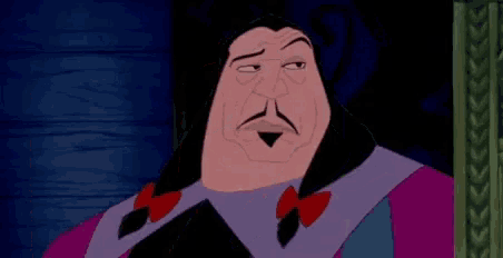 a cartoon character with a beard and mustache is sitting in a chair and making a face .