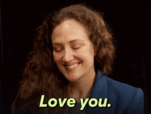 a woman is smiling and says love you