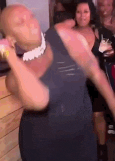 a woman in a black dress is dancing in a room .