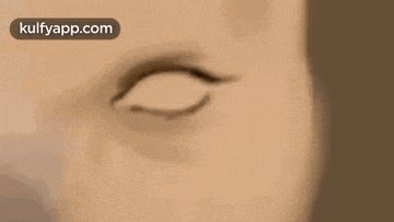 a close up of a person 's eyes with a cell phone in the background .