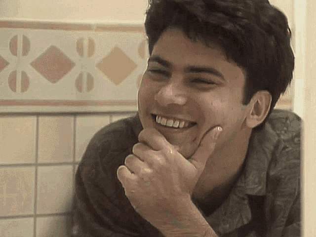 a man with a ring on his finger is smiling