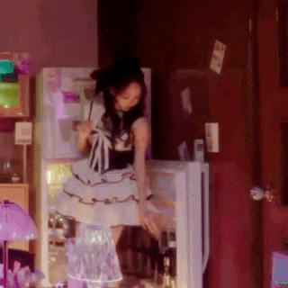 a woman in a white dress is standing in front of a refrigerator with a sticker on it that says ' a '