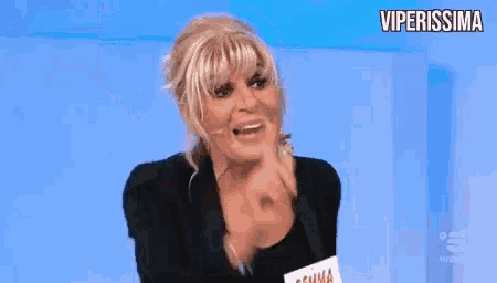 a woman wearing a name tag that says gemma is making a funny face .